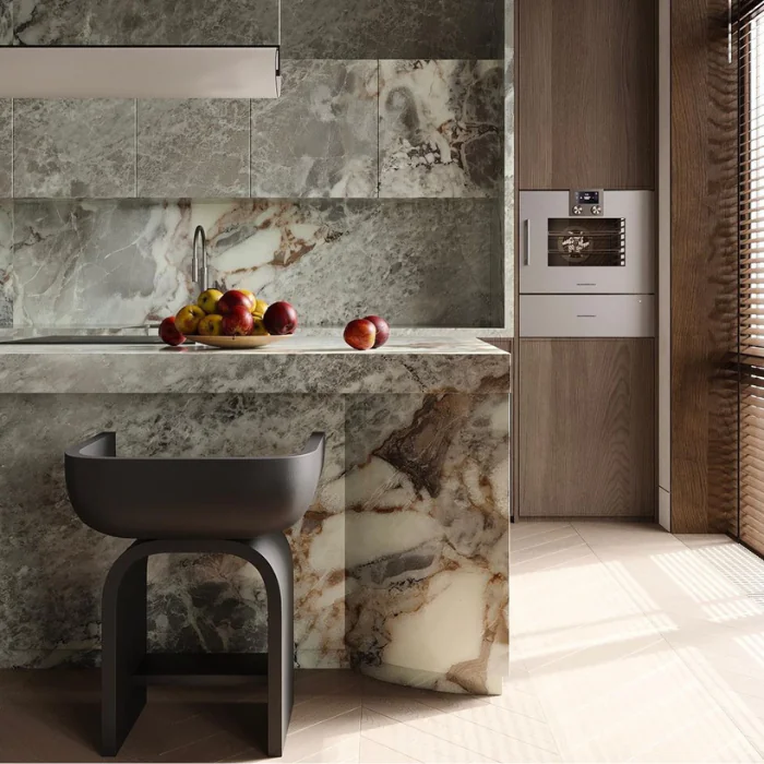 3D Visualisierung Einleitung Eine 3D-Visualisierung von einer stilvollen Küchen mit charakterstarkem Naturstein, eingelassener Spüle, Designhocker und Obstschale als Farbkontrast.